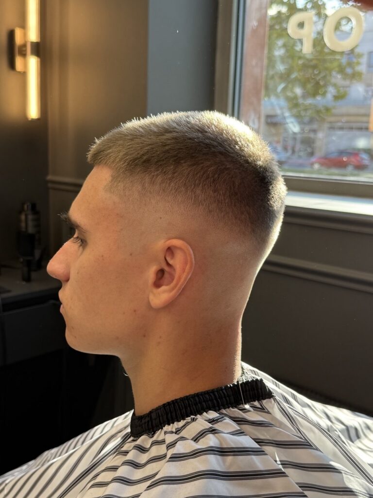 Crew cut with high skin fade, profile view, by barber Denis at BRODSKI Barbershop Wilanów, Warszawa